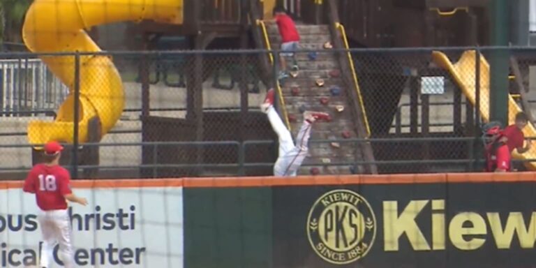 Houston outfielder goes over the wall to rob home run